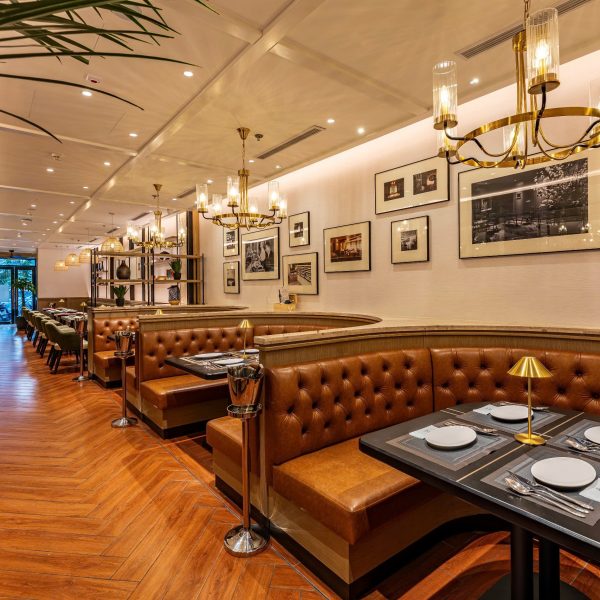 The Royal restaurant interior in District 1 Saigon with warm lighting, wooden tables and elegant dining space.