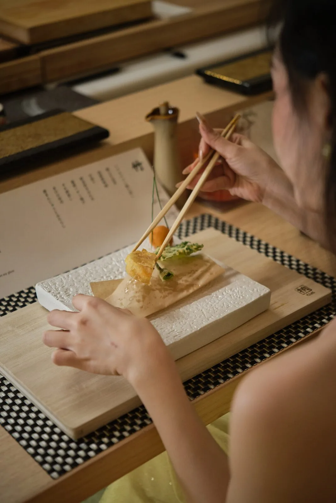 A guest enjoying the meal at the sushi counter