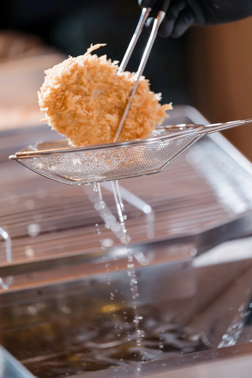 A cutlet just lifted from the fryer