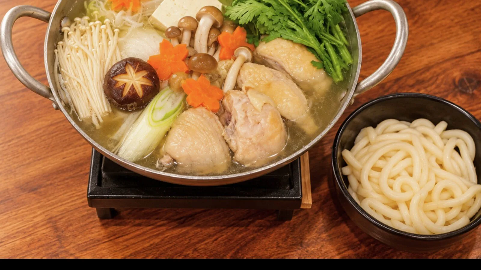 A clear mizutaki hotpot with chicken and vegetables