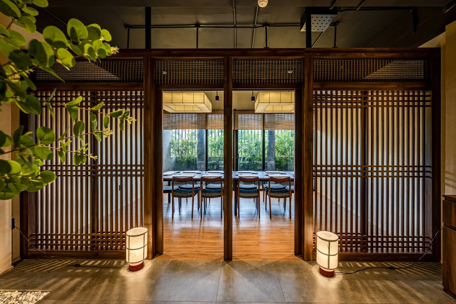 A banquet table set in a private room overlooking greenery